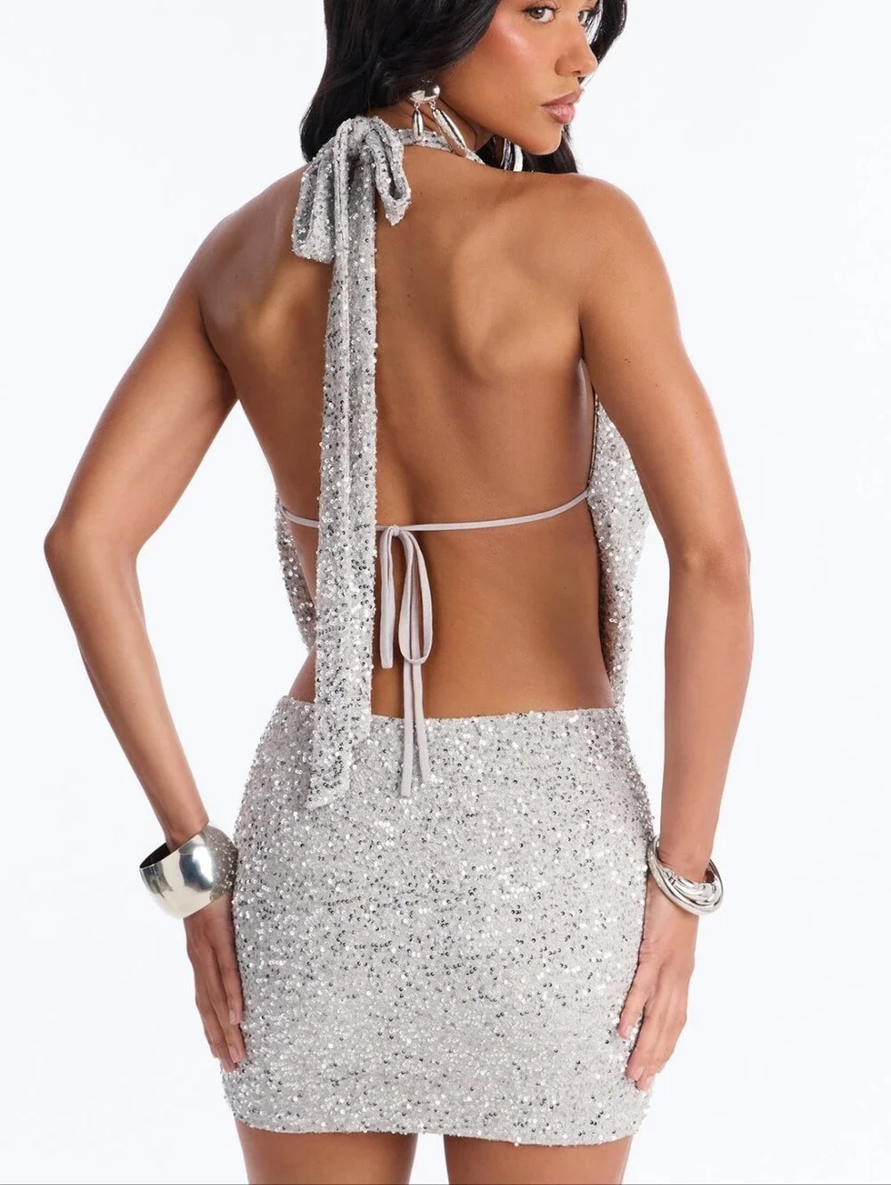 A sophisticated and bold silver evening outfit, completely covered in shiny